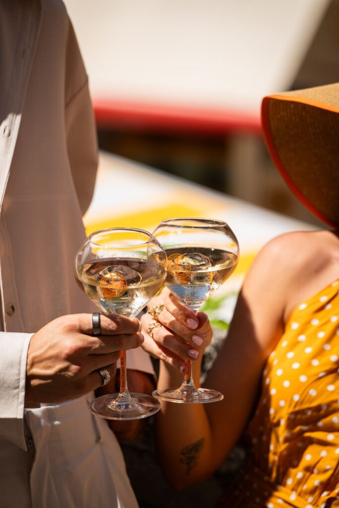 Two Veuve Clicquot glasses raised in a toast